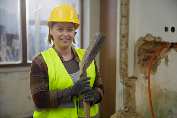Woman portrait. Dust covered construction site in a back. Home improvement, reconstruction.