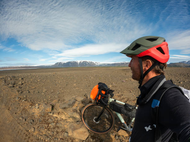 istock Cyclist Admiring Rocky Landscape with Snow-Capped Mountains 2159477183