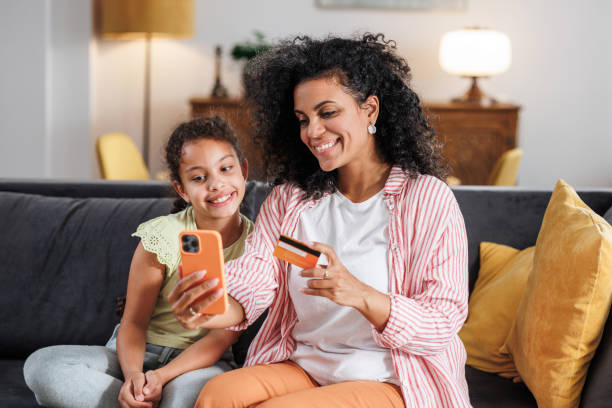 istock Mother and daughter making an online purchase 2159477837