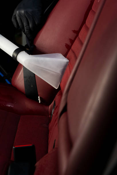istock Detailing auto seat using vacuum extractor. Removing dirt from car seat with the help of special hoover nozzle. 2159478910