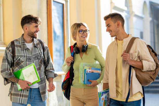 istock Cheerful woman with two male student, happily discussing their studying 2159479066