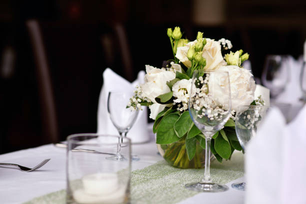 istock Wedding table setting with  flower bouquets and drinking glasses 2159480895