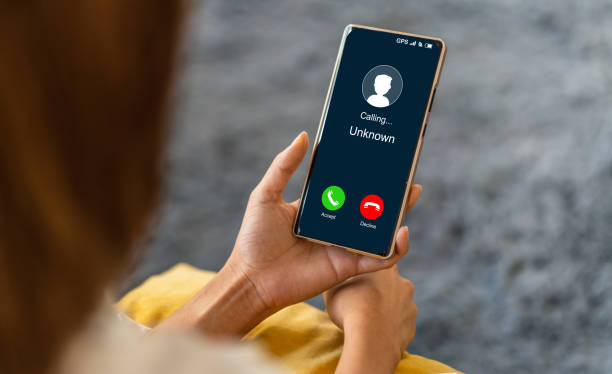 istock Human use smartphone with incoming call from unknown number, spam, prank caller, hoax person, fake identity, scammer, scam with mobile phone, hacker, call center, crime, call, fraud or phishing concept 2159481402