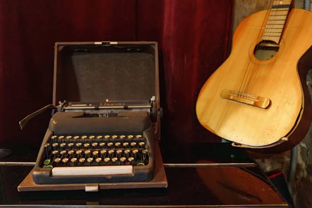 istock A guitar and a typewriter in a room with red curtains and a brick wall. 2159481781