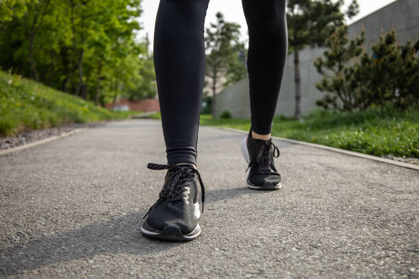 istock Woman running during sunny morning on stadium track 2159482443