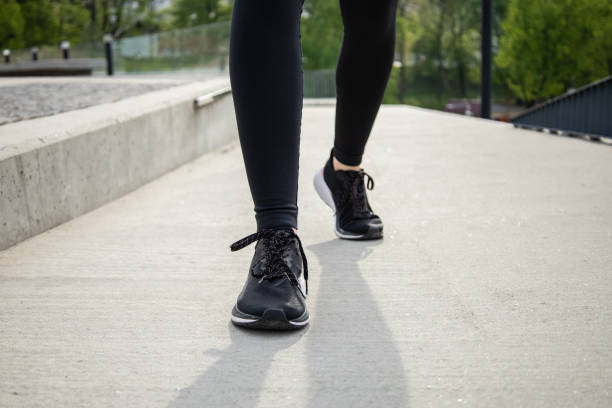 istock Woman running during sunny morning on stadium track 2159482480