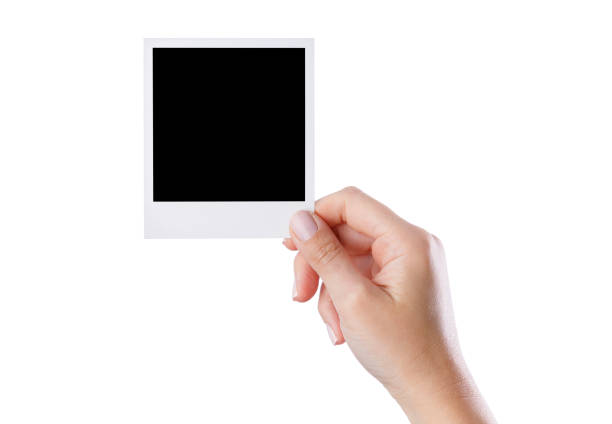 istock Hand holding blank photo frame on isolated white background 2159483735