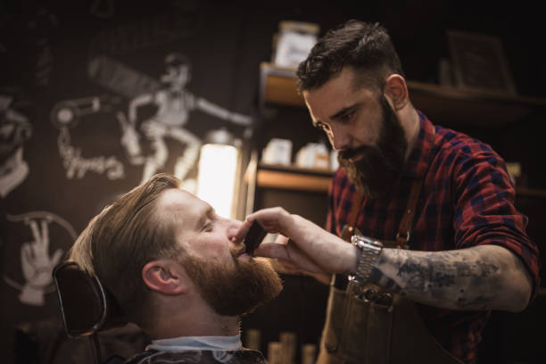 istock Barber Trimming Beard in Modern Barbershop 2159484781