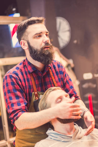 istock Barber Performing Grooming Service on Client in Modern Barbershop, Morning 2159484794