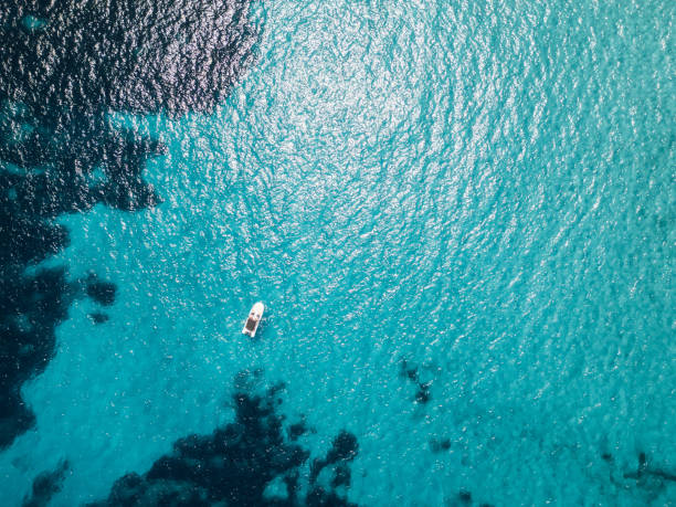 istock White boat sailing on transparent turquoise water in summer 2159486720