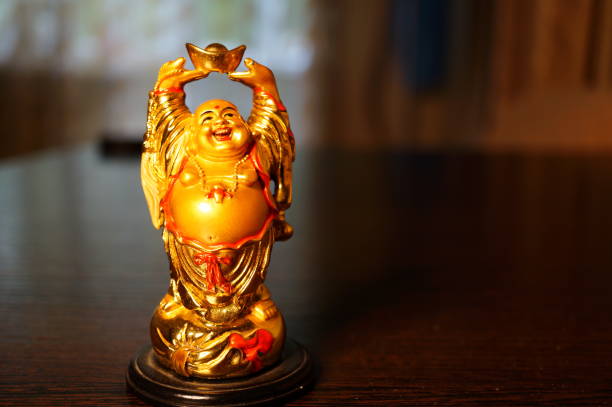 istock A statuette of a smiling Buddha on the table. 2159488529