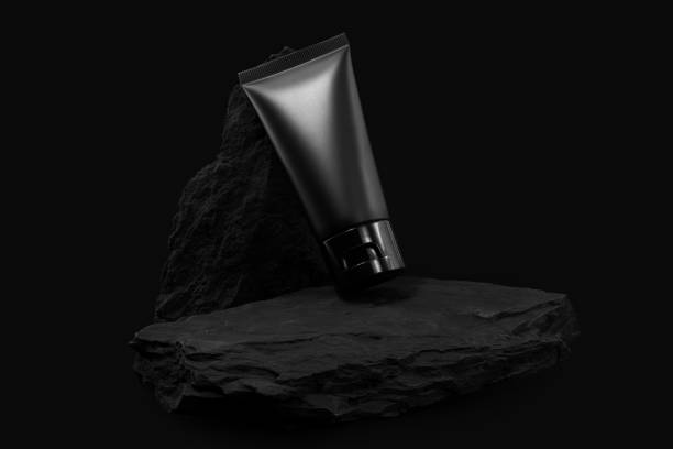 istock Black cream tube on black stone. For mockup. 2159489125