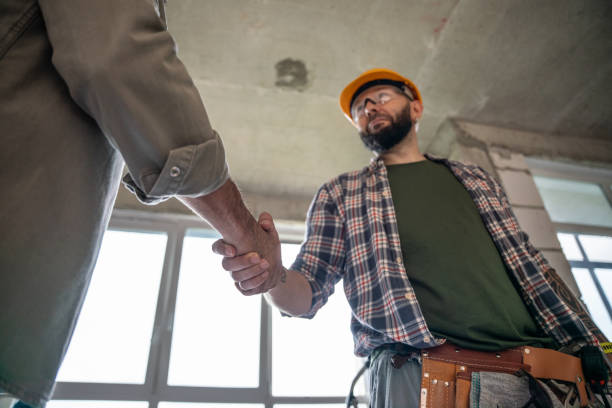 istock Handshake at construction site. Construction worker handshakes hands with a home owner 2159489160