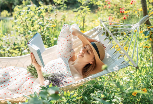 istock Young woman relaxing in a hammock outdoors in back yard 2159489225