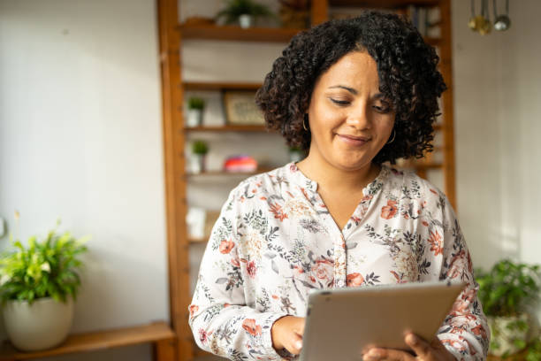 istock Happy woman using digital tablet at home office 2159489286