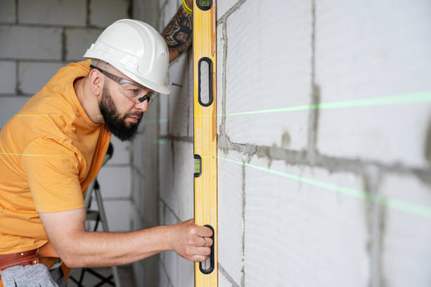 istock Construction worker examining walls with a spirit level 2159489634