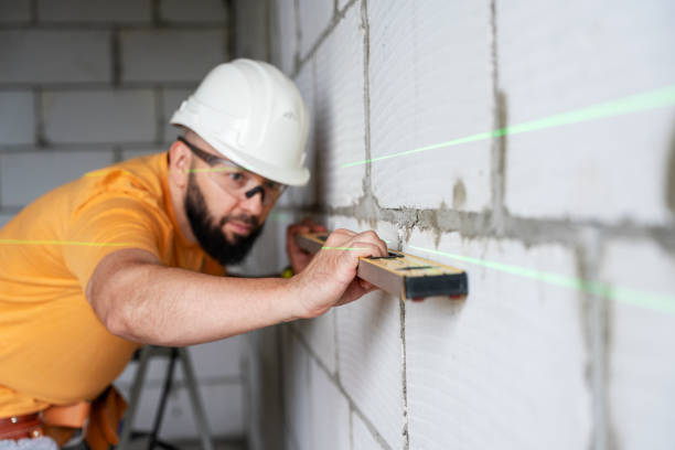 construction worker examining walls with level at construction site - murare bildbanksfoton och bilder
