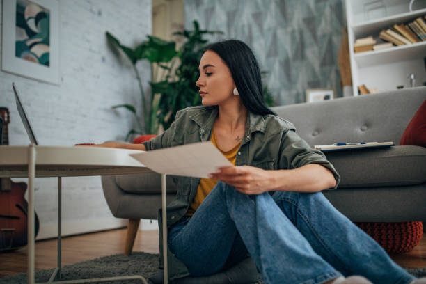 istock Woman reviewing documents for online shopping transaction 2159491299