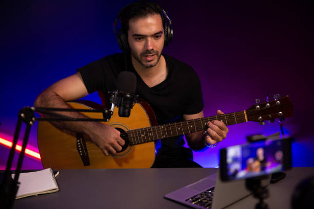 istock Influencer creative audio on live streaming with sing with play guitar. Surmise. 2159491449