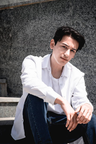 istock Handsome young man, student sits on steps in city 2159495042