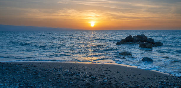 istock Sunset by the sea, the sky is reflected in the smooth sea 2159495405