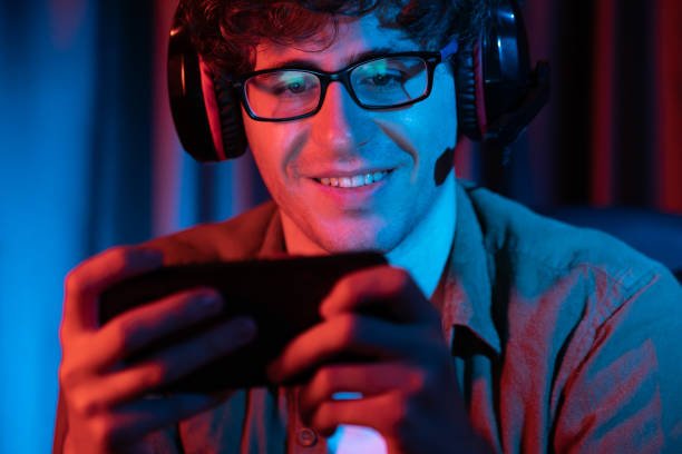 istock Smiling streamer team playing with Esport online on smartphone. Gusher. 2159495820