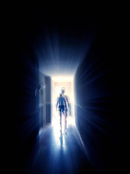 istock One man walking in narrow corridor in to glowing light 2159499737