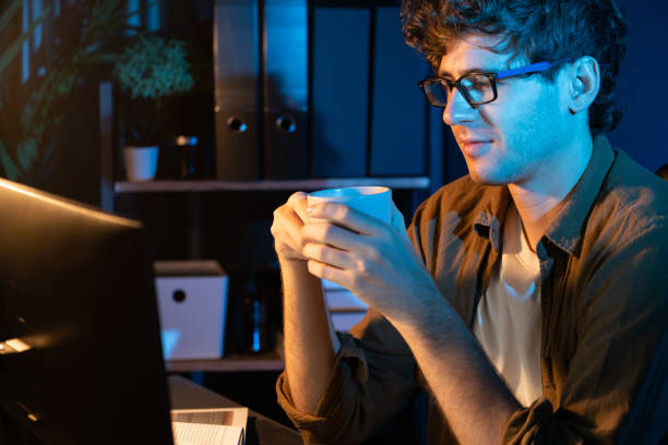 istock Young businessman working job, drinking hot drink with coffee or tea. Gusher. 2159501230