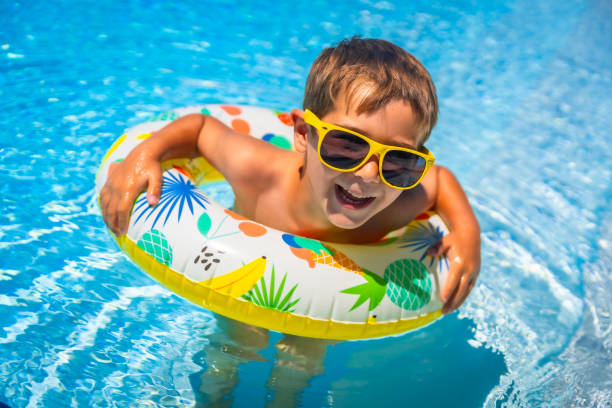 istock Boy having fun in the swimming pool in summer 2159502543