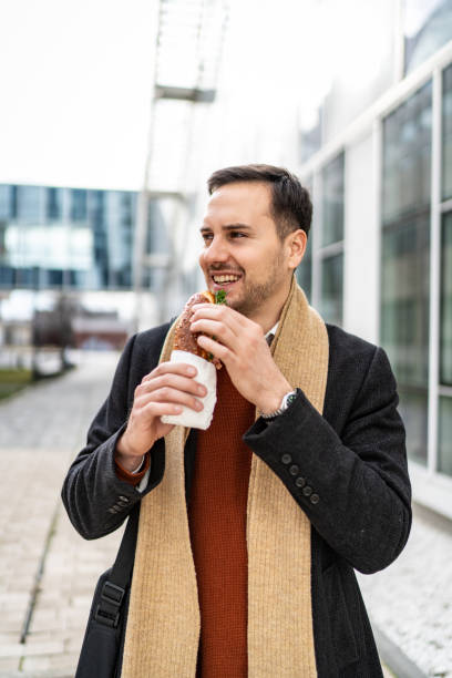 istock Businessman eating sandwich 2159505239