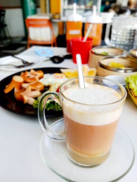 istock hot milk tea  with white cream on top on table 2159505955
