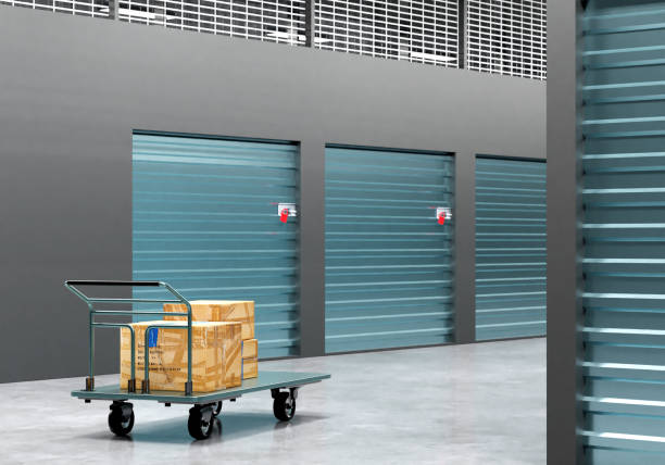 istock Self storage units. Boxes on cart near storage units. Concept - renting space in warehouse. Container rental for safekeeping. Storage company visualization. Large warehouse without anyone. 3d image. 2159506033