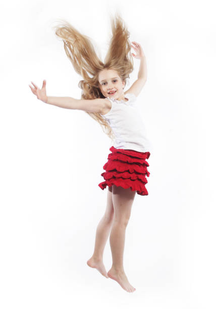 little girl jumps on a white background