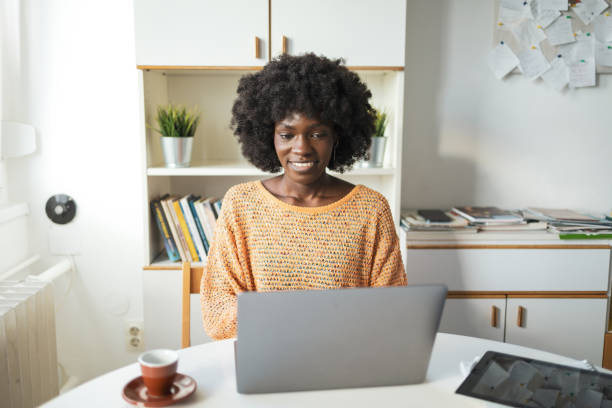 istock Happy woman working on laptop in home office 2159507581