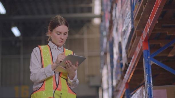 istock Professional warehouse workers checks products stock inventory with digital tablet in warehouse full of shelves, Workers employee doing work in storehouse. Concept of people, logistics, transportation, delivery, and distribution center. 2159509077