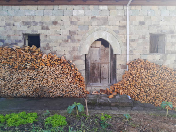 cut wood in front of an old building
