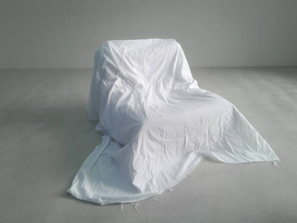 istock Armchair covered with a white cloth 2159510192