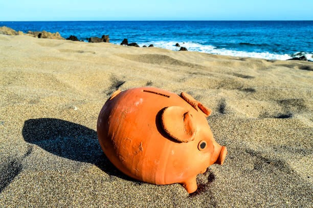 istock Piggy Bank on the Sand Beach 2159511080