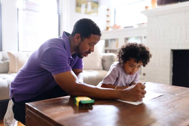 istock Father helping his little son to finish his homework 2159512504