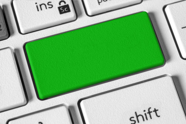 Computer keyboard with prominent green key, symbolizing go, start, or approval. Ideal for technology, productivity, and user interface themes. close-up, Copy space