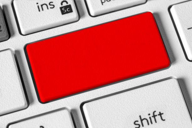 Modern white keyboard with blank red key to enter text or logo. The concept of urgency or action. Ideal for technology, security, or emergency-related themes. Copy space.