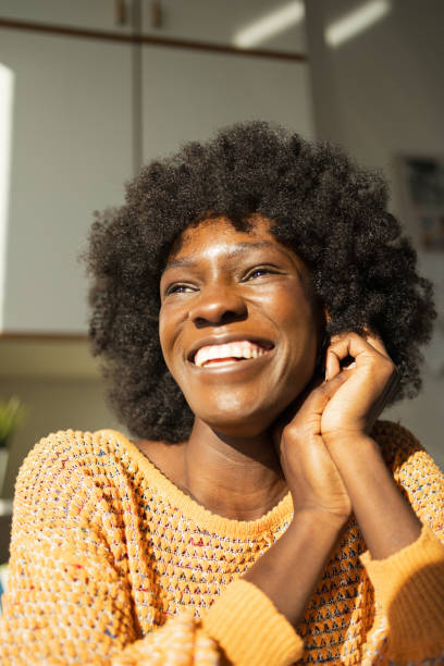 istock Happy thoughtful woman with hands clasped at home 2159513811