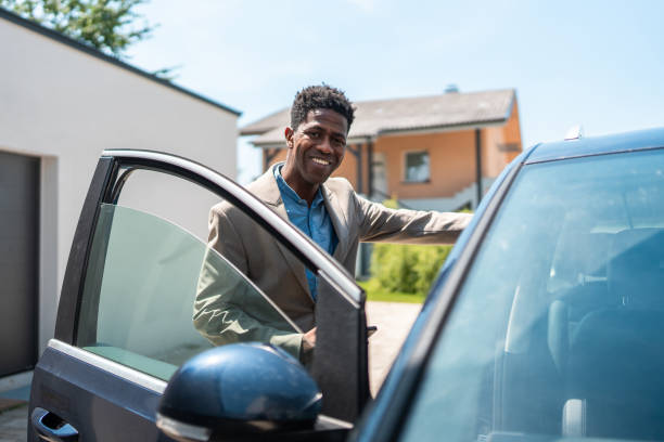 istock Professional Black Businessman Entering Vehicle for Work Commute 2159515092