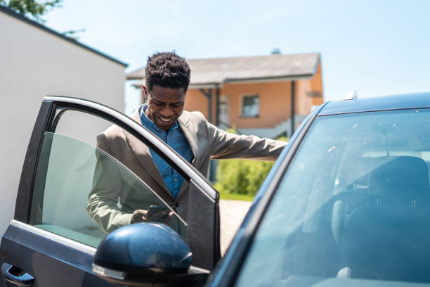 istock Professional Black Businessman Entering Car for Commute 2159515139