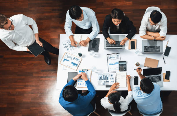 istock Analyst team utilizing BI Fintech to analyze financial data at table. Prudent 2159516204