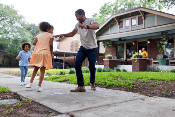 istock Happy father playing tag game with his daughter and son 2159518008