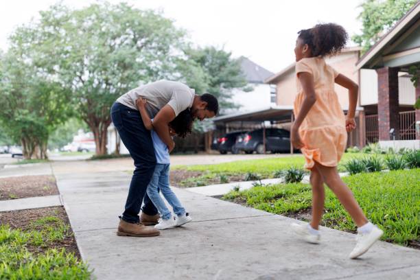 istock Little boy hugging his father while playing games outdoors 2159518328