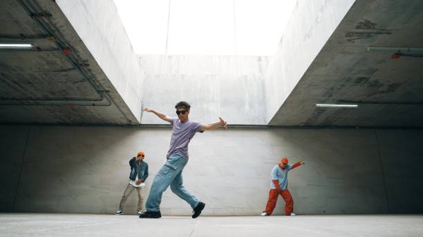 istock Group of stylish hipster group perform dancing together in building. Sprightly. 2159518635