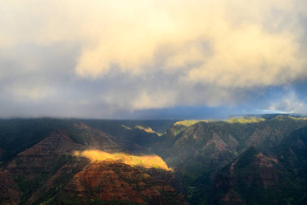 Detail with some spotlights of the Waimea Canyon on the island Kauai at sunset. It is the largest canyon in Hawaii.