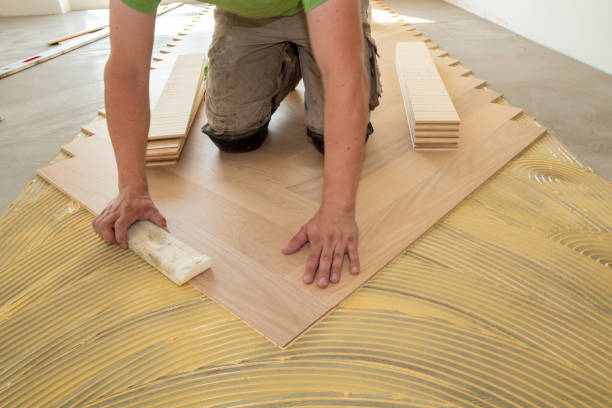 istock Craftsman laying herringbone parquet flooring professionally 2159522958